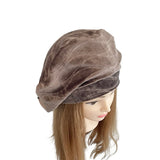 Brown velvet turban on a mannequin head with long brown hair against a white background