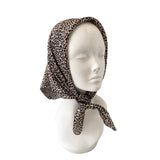 Leopard print headscarf on a mannequin head against a white background