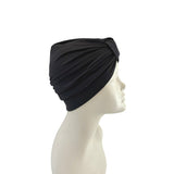 Black headscarf on a mannequin head against a white background