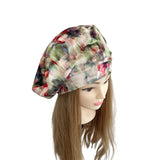 Colorful patterned headscarf on a mannequin head with long hair against a white background