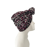 Leopard print headscarf on a mannequin head against a white background