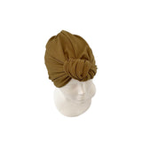 Brown turban on a mannequin head against a white background