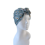 Gray headscarf with floral pattern on a mannequin head against a white background