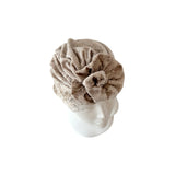Beige towel turban on a white background