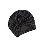Black textured beanie hat on a white background