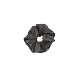 Black scrunchie with a pattern on a white background