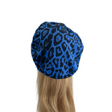 Blue leopard print headscarf on a mannequin head with blonde hair against a white background