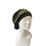 Green beanie on a mannequin head against a white background