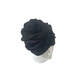 Black turban on a mannequin head against a white background