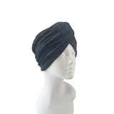 Black headscarf on a mannequin head against a white background