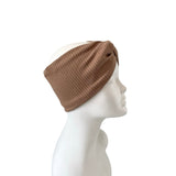 Brown knitted headband on a mannequin head against a white background