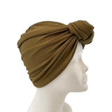Brown turban on a mannequin head against a white background