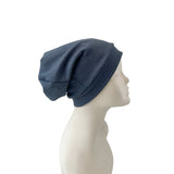 Blue knit beanie on a mannequin head against a white background