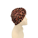 Leopard print headscarf on a mannequin head against a white background
