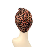 Leopard print headscarf on a mannequin head against a white background