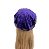 Purple satin bonnet on a mannequin head with blonde hair against a white background