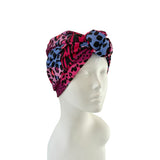Colorful patterned headscarf on a mannequin head against a white background
