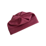A dusty burgundy fleece beanie hat with a large decorative bow on top, shown on a plain white background.