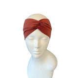 Brown headband on a mannequin head against a white background