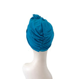 Blue headscarf on a mannequin head against a white background
