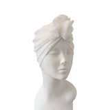 White towel turban on a mannequin head against a white background
