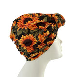 Sunflower patterned headscarf on a mannequin head against a white background