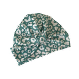 Green headscarf with white leopard print pattern on a white background