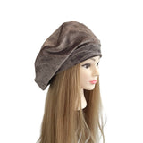 Brown headscarf on a mannequin head with long hair against a white background