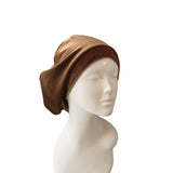 Brown headscarf on a mannequin head against a white background