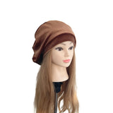 Mannequin head with a brown beret on a white background