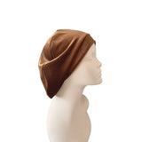 Brown headscarf on a mannequin head against a white background