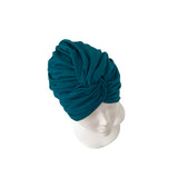 Teal headscarf on a mannequin head against a white background