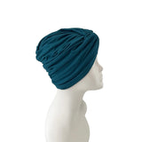 Blue headscarf on a mannequin head against a white background