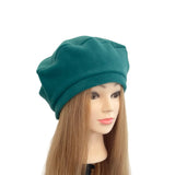 Teal beanie on a mannequin head with long brown hair against a white background
