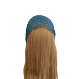 Blue lace headband on a wig with blonde hair against a white background