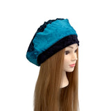 Blue satin bonnet on a mannequin head with long brown hair against a white background