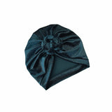 Dark blue knitted turban on a white background