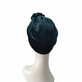 Dark blue knit headband on a mannequin head against a white background