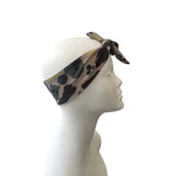 Camo-patterned headband on a mannequin head against a white background