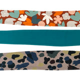 Three fabric swatches with floral, solid teal, and abstract patterned designs on a white background.