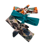 Three colorful hair bows on a white background