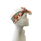 Floral patterned headband on a mannequin head against a white background