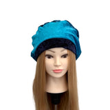 Blue headscarf on a mannequin head with long hair against a white background