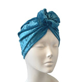 Blue textured headscarf on a mannequin head against a white background
