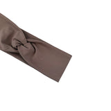 A taupe brown fabric headband with a twisted knot detail, shown on a plain white background.