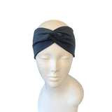 Dark gray headband on a mannequin head against a white background ireland