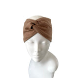 Brown knitted headband on a mannequin head against a white background