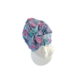 Colorful headscarf on a white mannequin head against a white background