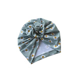 Green headscarf with floral pattern on a white background
