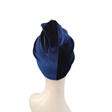Navy blue headscarf on a mannequin head against a white background